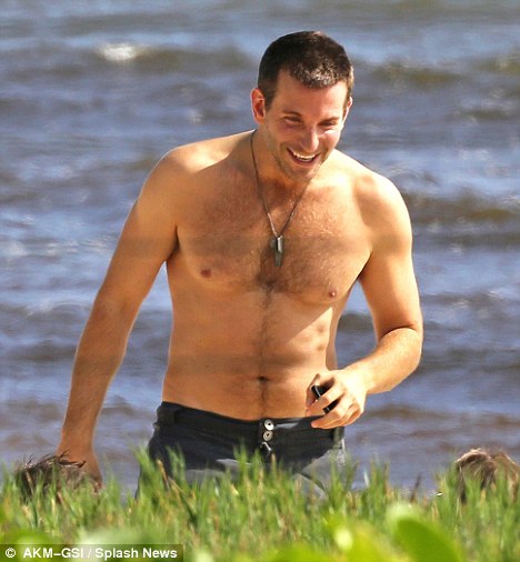 Bradley Cooper shows off his torso as he sunbathes