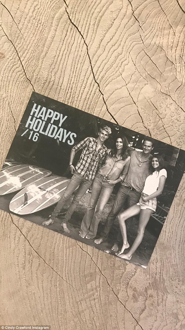Altogether now: As many of their cards had a beach theme, their latest card showed all four family members posed up next to surfboards 