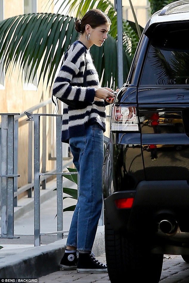 Cutie: Kaia stepped out in Malibu on Friday afternoon wearing blue jeans and a navy and white striped sweater with her brown hair tied back in a loose bun