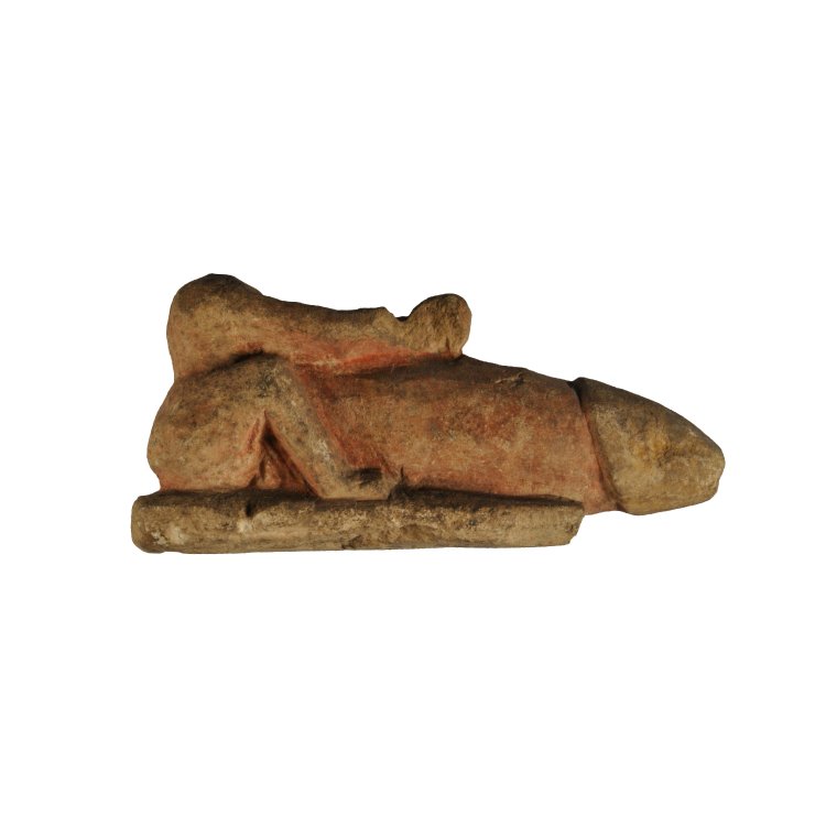 Limestone seated figure with large phallus; traces of pink paint; head lost