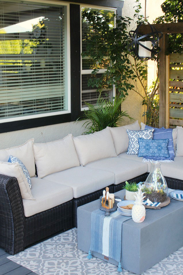 Beautiful covered summer patio with outdoor sofa.